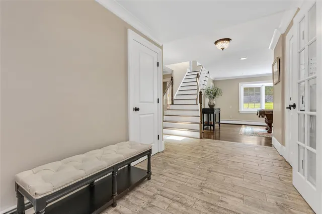 a view of a hallway with wooden floor and staircase