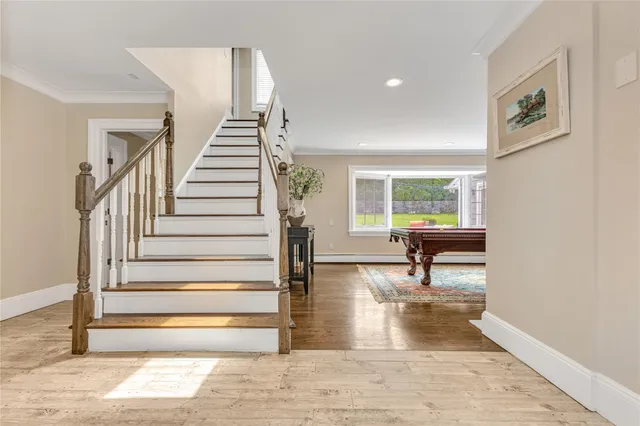 a view of entryway and hall with wooden floor