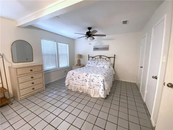 a bedroom with a bed and a dresser
