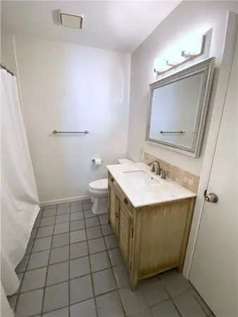 a bathroom with a sink a toilet and mirror