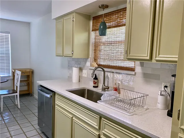 a kitchen with a sink a stove and cabinets