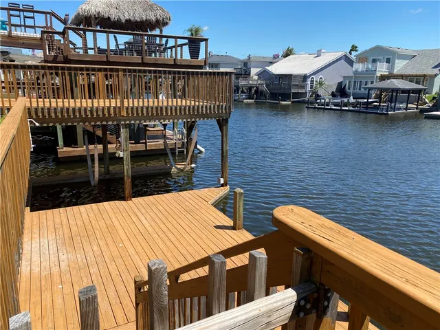 a balcony with wooden floor and outdoor seating