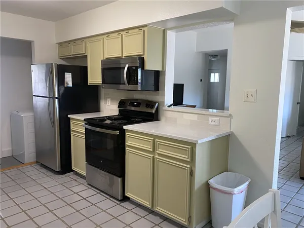 a kitchen with stainless steel appliances a sink and a refrigerator