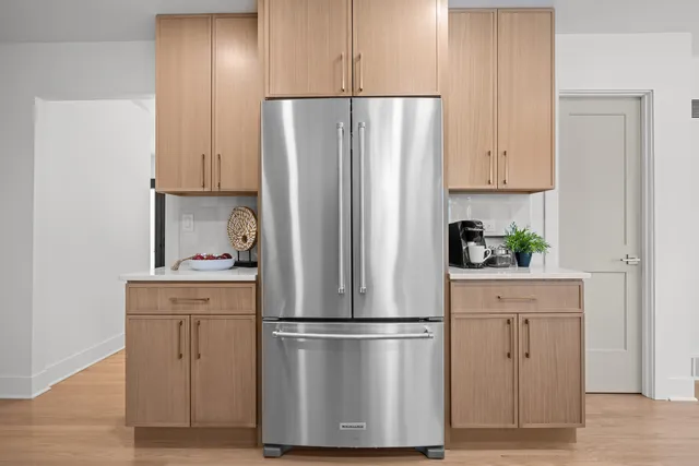 a white refrigerator freezer sitting in a kitchen