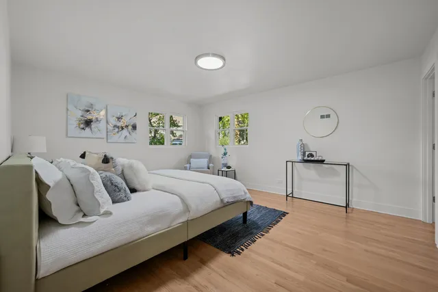 a spacious bedroom with a bed and a window