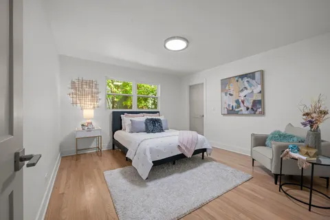 a bed room with a bed and a chair