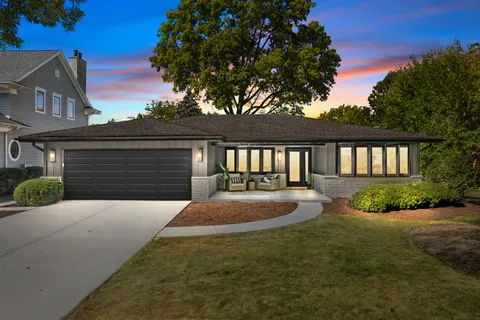 a front view of a house with yard and garage