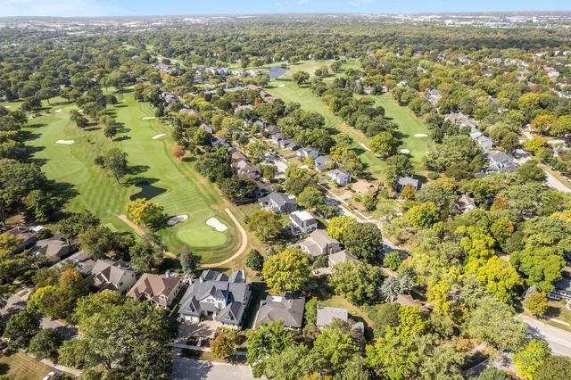 an aerial view of a residential houses with city view