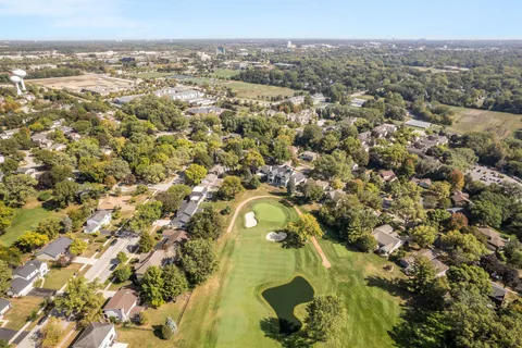 an aerial view of a house with a yard