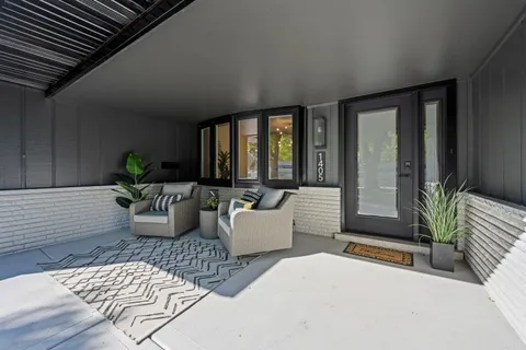 a living room with furniture and a potted plant