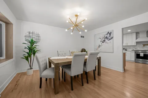 a view of a dining room with furniture and wooden floor