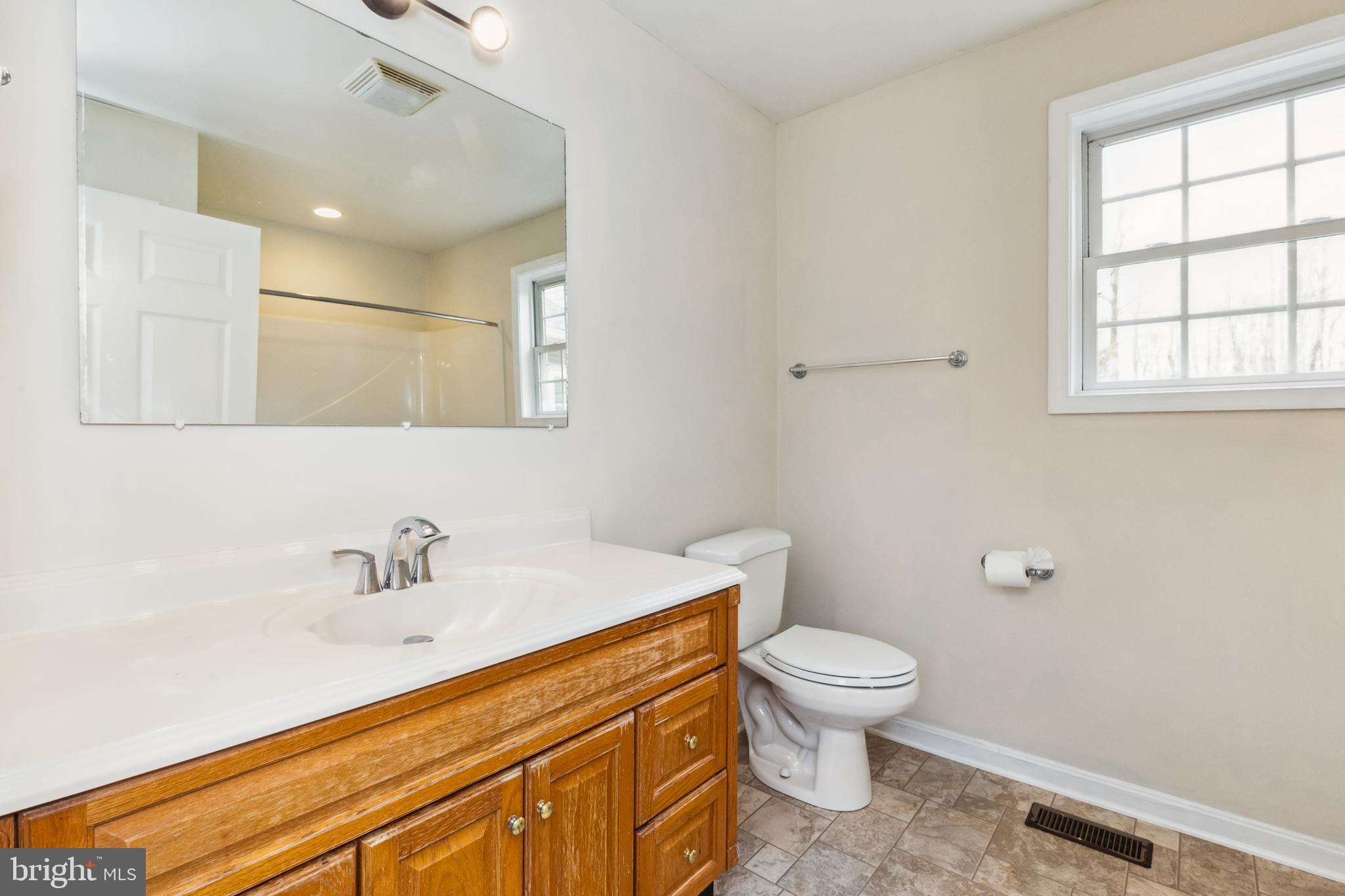 13157 Mt Paran Church Road Linden, VA 22642 - Photo 12 of 27 a bathroom with a sink a toilet and a window