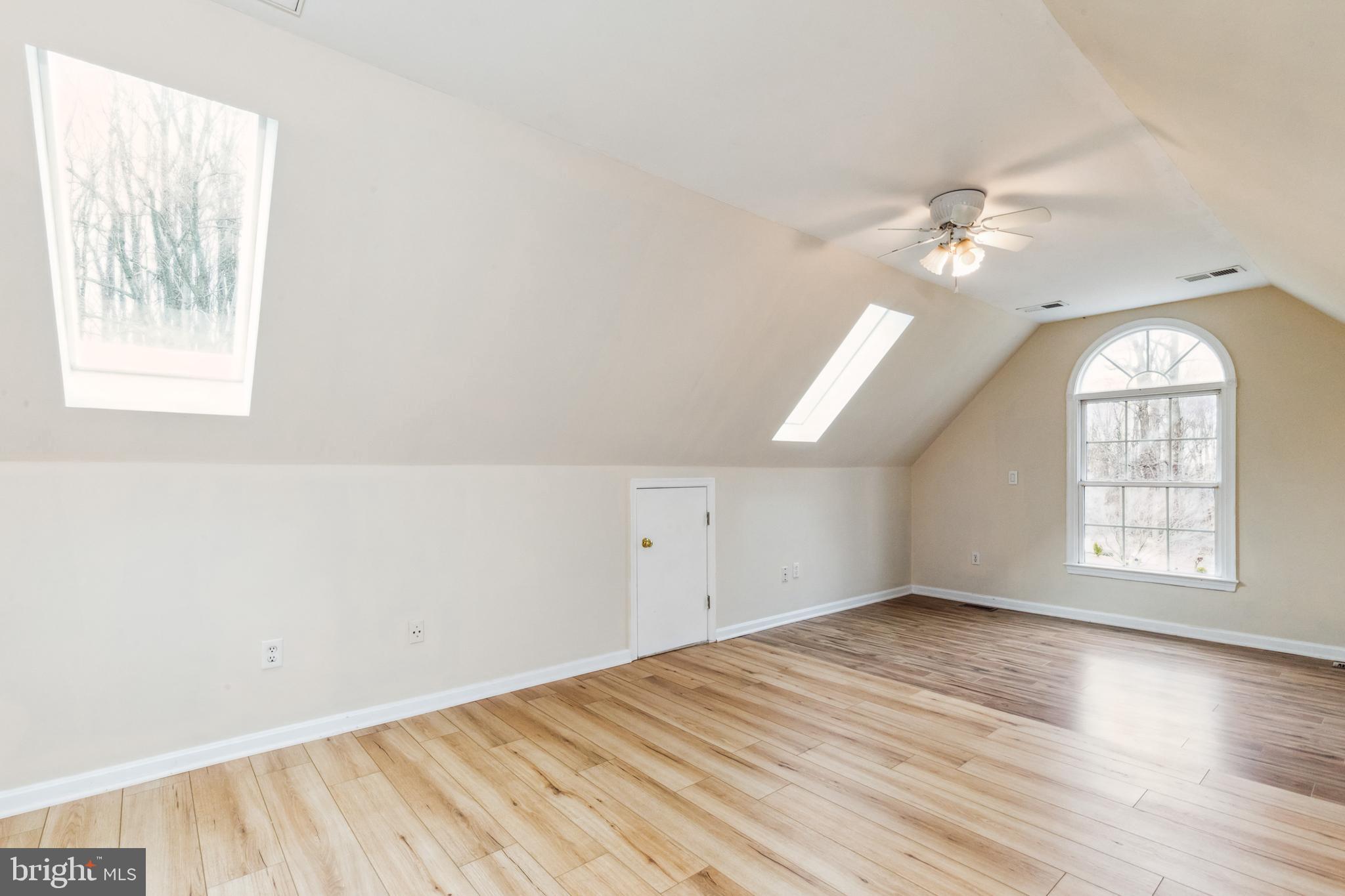 13157 Mt Paran Church Road Linden, VA 22642 - Photo 13 of 27 an empty room with wooden floor chandelier fan and windows