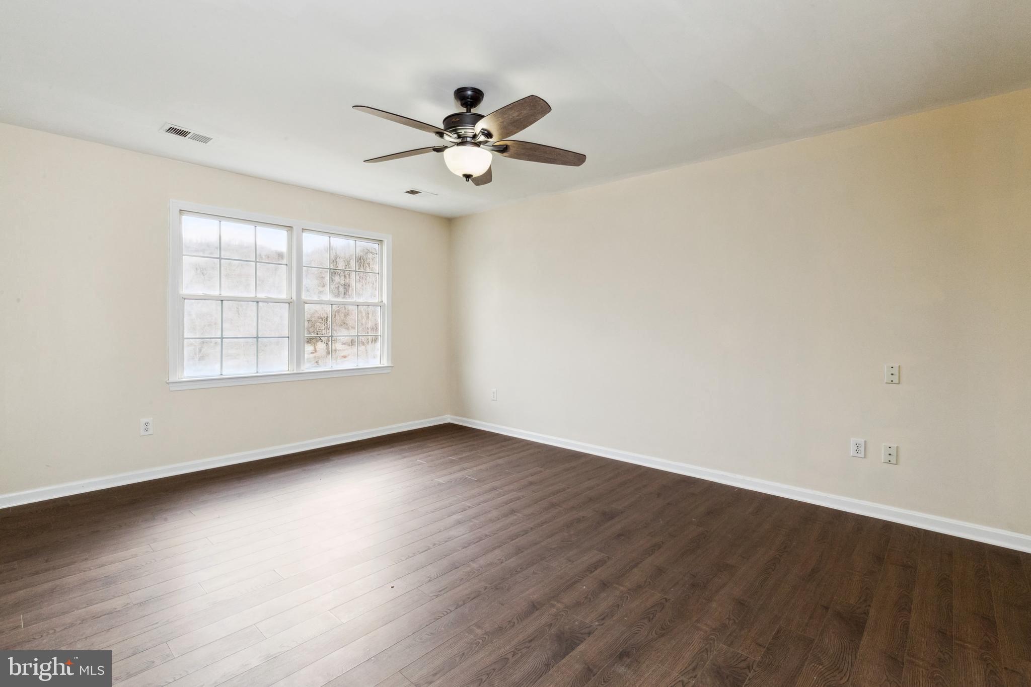 13157 Mt Paran Church Road Linden, VA 22642 - Photo 19 of 27 an empty room with wooden floor fan and windows