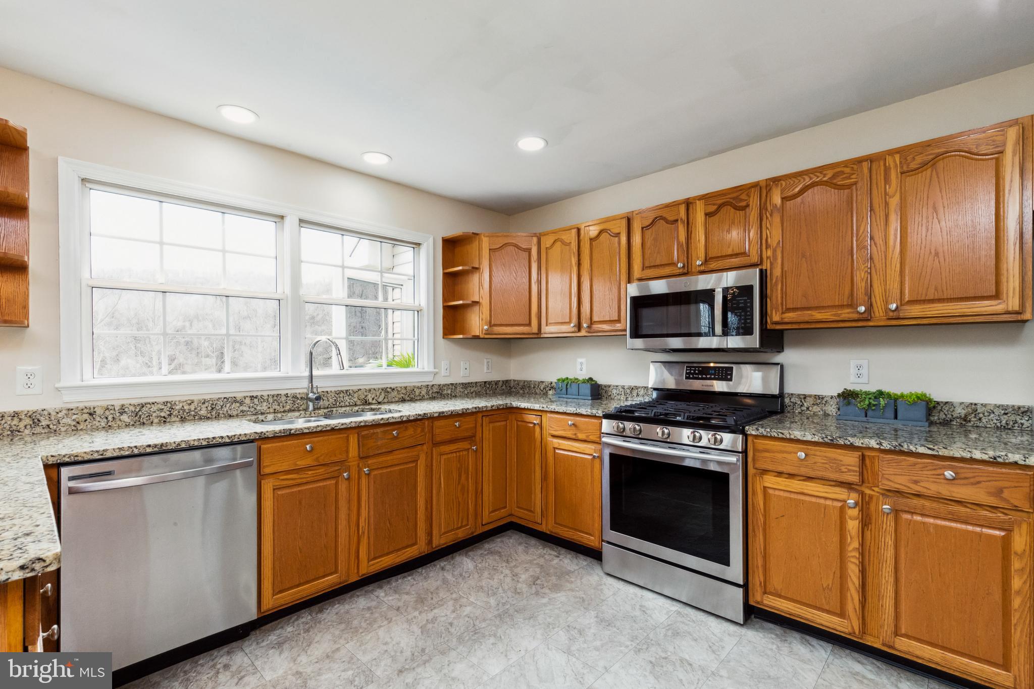 13157 Mt Paran Church Road Linden, VA 22642 - Photo 6 of 27 a kitchen with stainless steel appliances granite countertop wooden cabinets a sink and a stove
