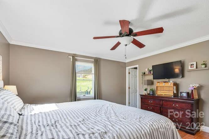 1423 Beaverdam Road Canton, NC 28716 - Photo 22 of 40 a bedroom with a bed and a flat screen tv