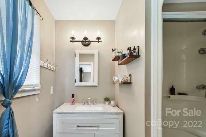 1423 Beaverdam Road Canton, NC 28716 - Photo 23 of 40 a bathroom with a sink and a mirror