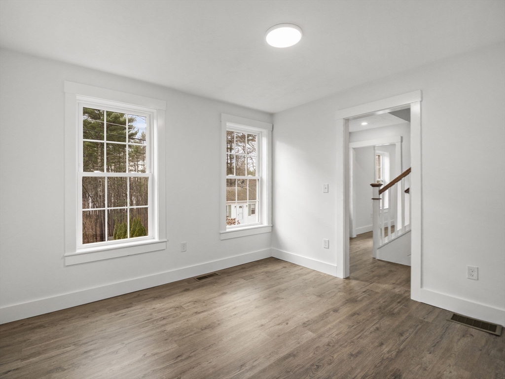 61 Arrow Groton, MA 01450 - Photo 17 of 42 an empty room with wooden floor and windows