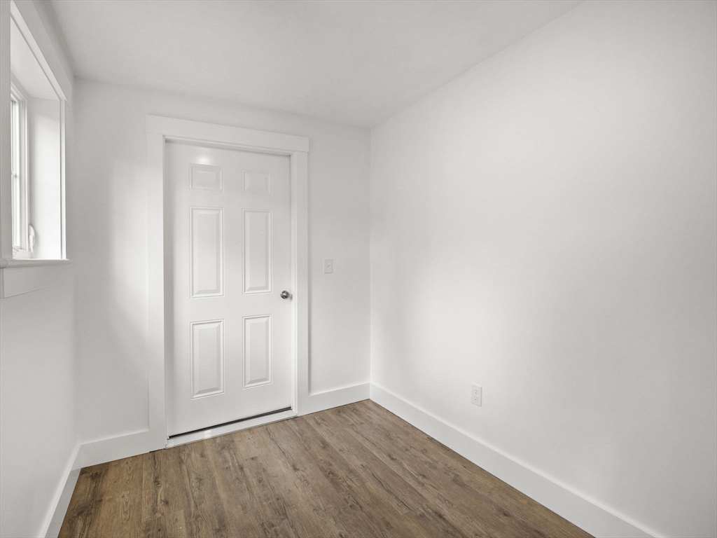 61 Arrow Groton, MA 01450 - Photo 34 of 42 a view of an empty room with wooden floor and a window