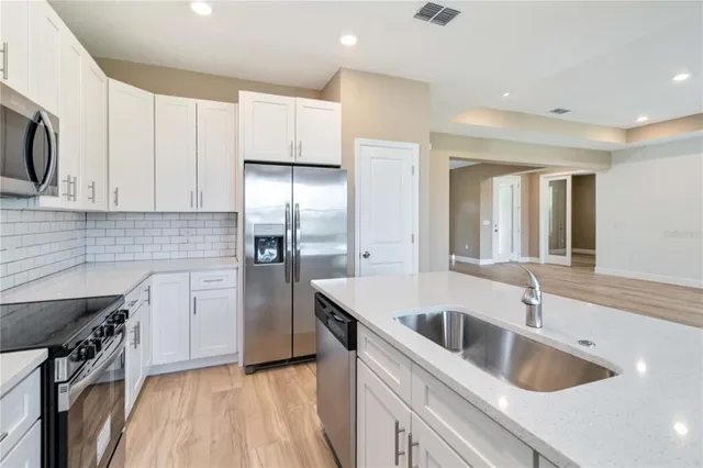 a kitchen with a sink and refrigerator