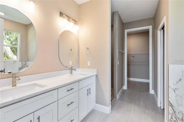 a bathroom with a double vanity sink and a mirror