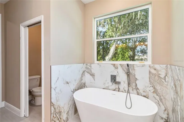 a bath tub sitting next to a window