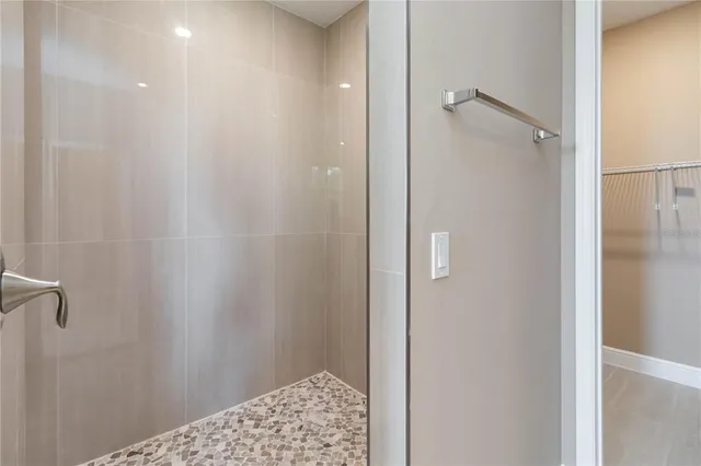 a bathroom with a glass shower door