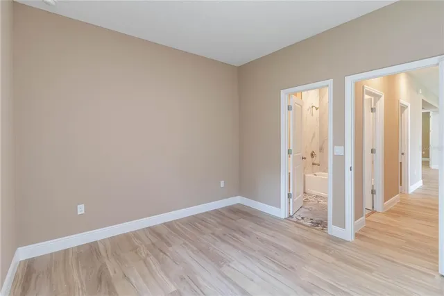 a bathroom with a sink and mirror with bathtub