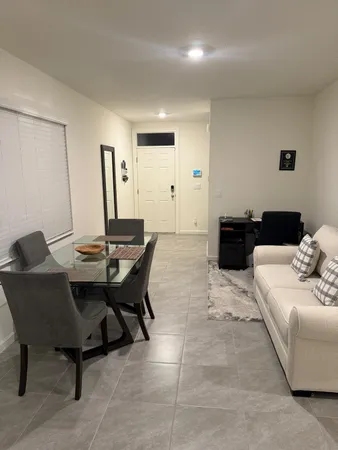 a view of a livingroom with furniture and chandelier fan