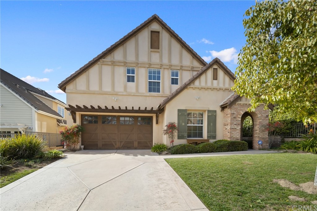 a front view of a house with a garden and plants