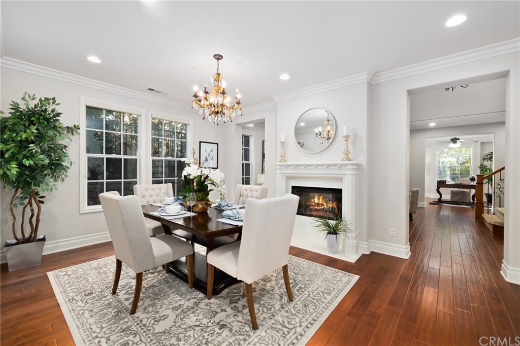 825 Cambridge Court Pasadena, CA 91107 - Photo 14 of 58 a dining room with furniture wooden floor a rug a potted plant and a fireplace