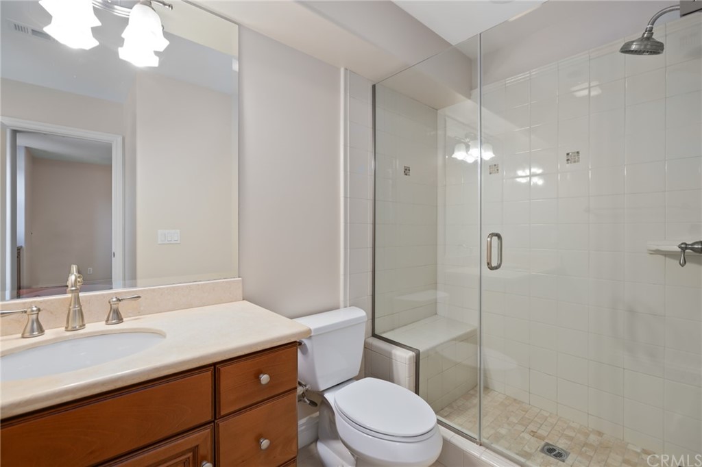 825 Cambridge Court Pasadena, CA 91107 - Photo 41 of 58 a bathroom with a sink a toilet a mirror and shower