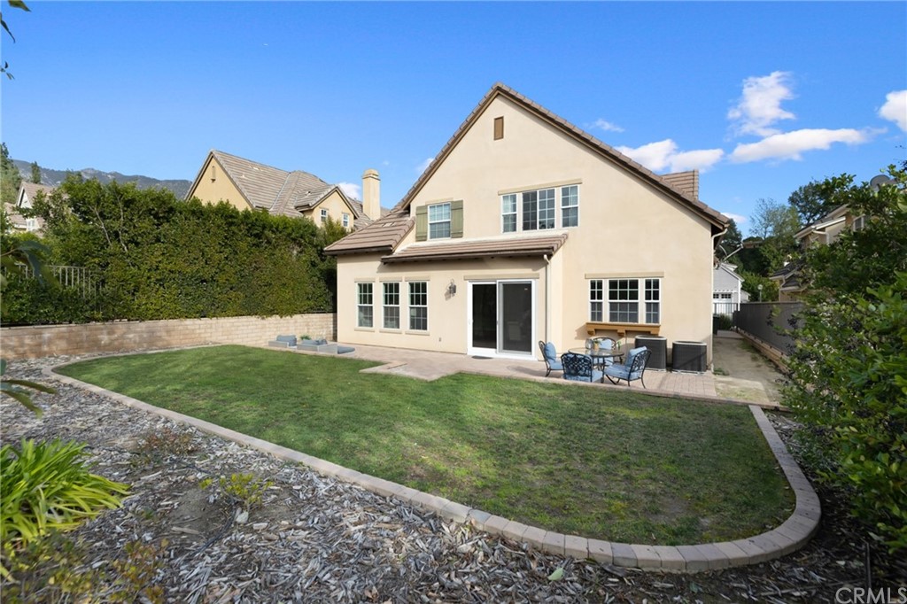 825 Cambridge Court Pasadena, CA 91107 - Photo 51 of 58 a view of a white house with a big yard potted plants and large tree