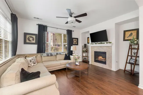 a living room with furniture a fireplace and a flat screen tv
