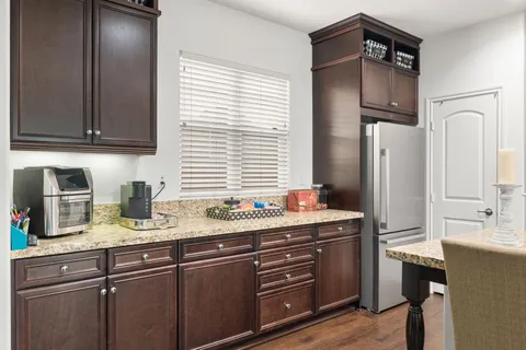 a kitchen with a refrigerator and a sink