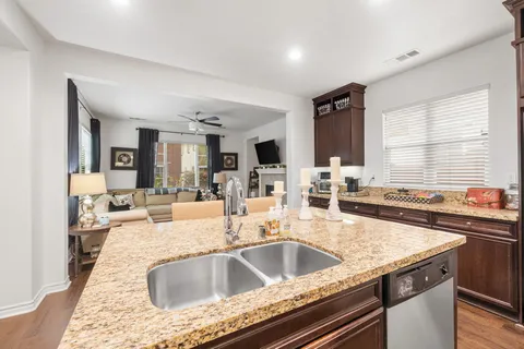 a kitchen with a sink and living room