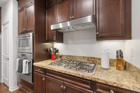 a kitchen with granite countertop stainless steel appliances and cabinets