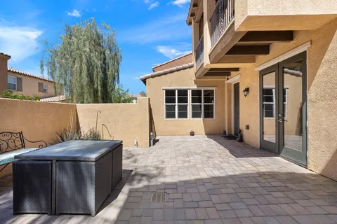 a view of a house with backyard and sitting area