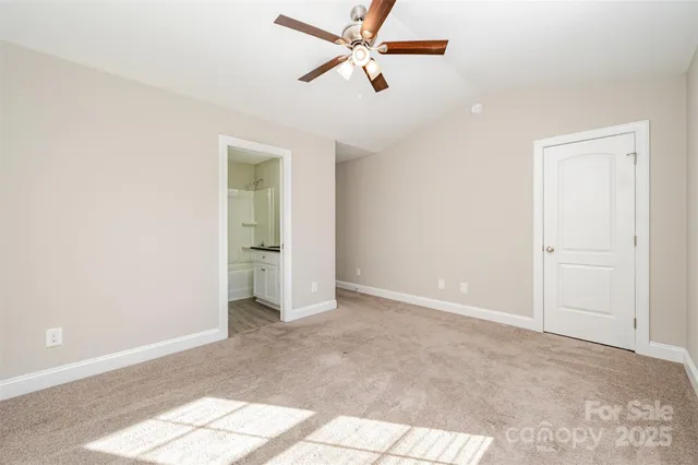 an empty room with fan and windows