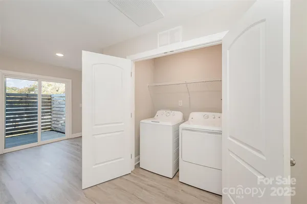 a view of storage and utility room with washer and dryer