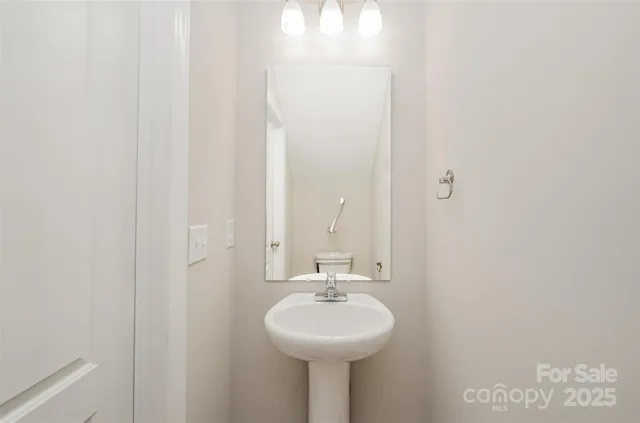 a bathroom with a sink a mirror and a shower