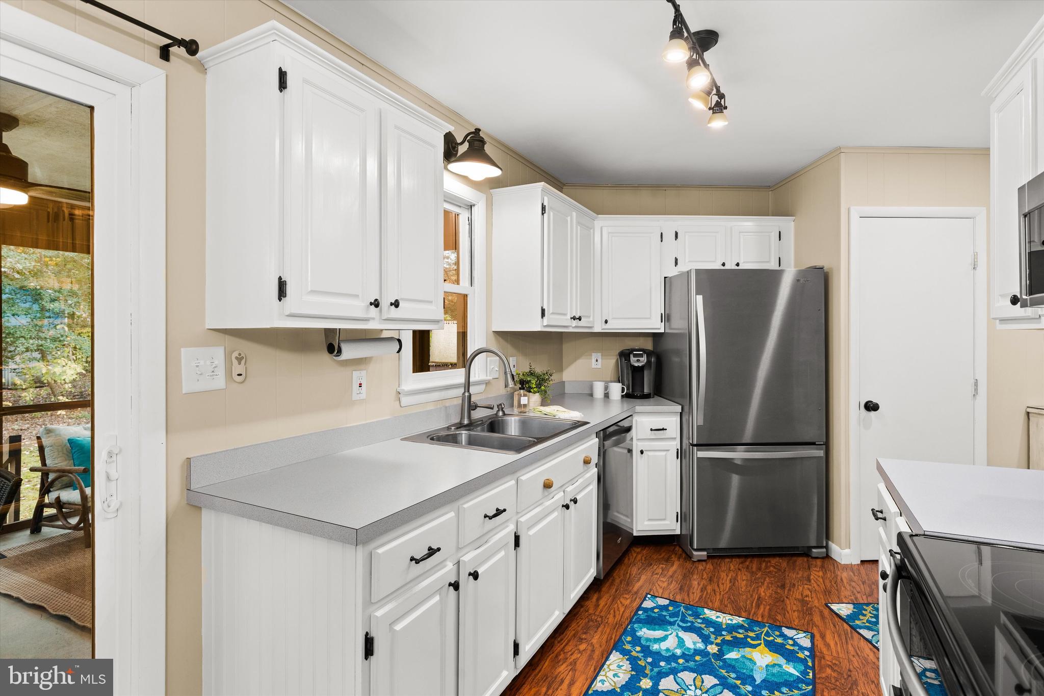 606 Spring Lake Court Bethany Beach, DE 19930 - Photo 12 of 53 a kitchen with a white cabinets and refrigerator