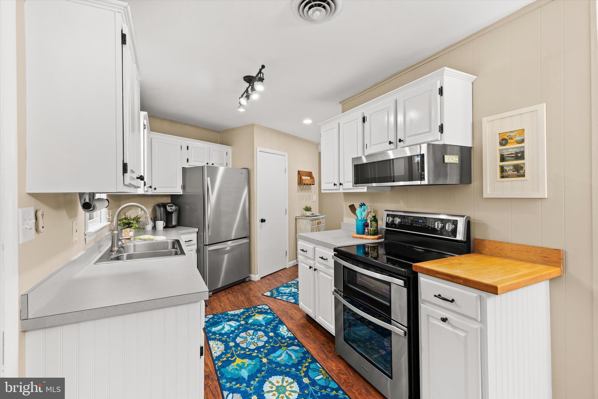 606 Spring Lake Court Bethany Beach, DE 19930 - Photo 13 of 53 a kitchen with stainless steel appliances a stove a sink and a refrigerator