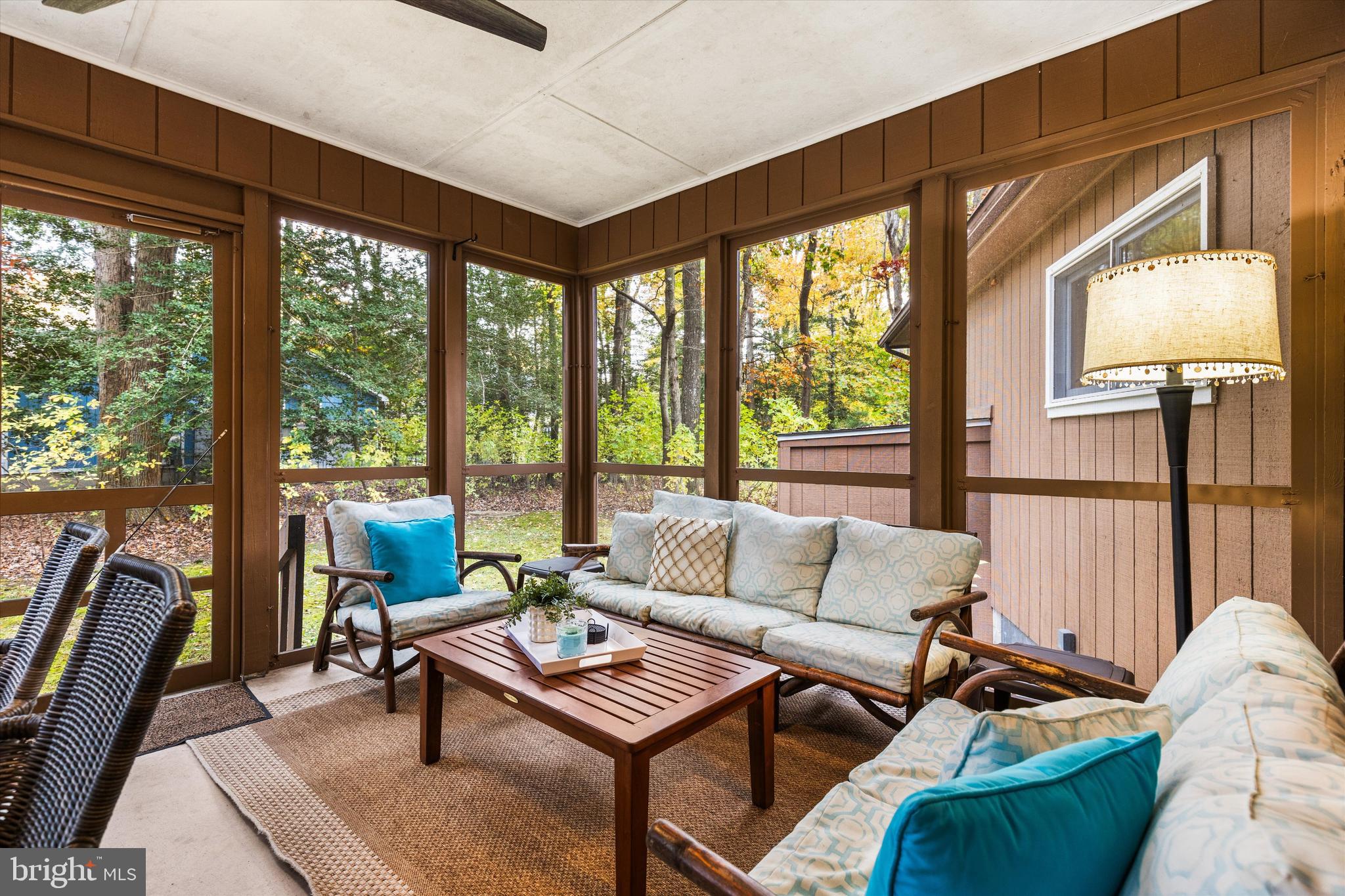 606 Spring Lake Court Bethany Beach, DE 19930 - Photo 20 of 53 a living room with furniture and a floor to ceiling window
