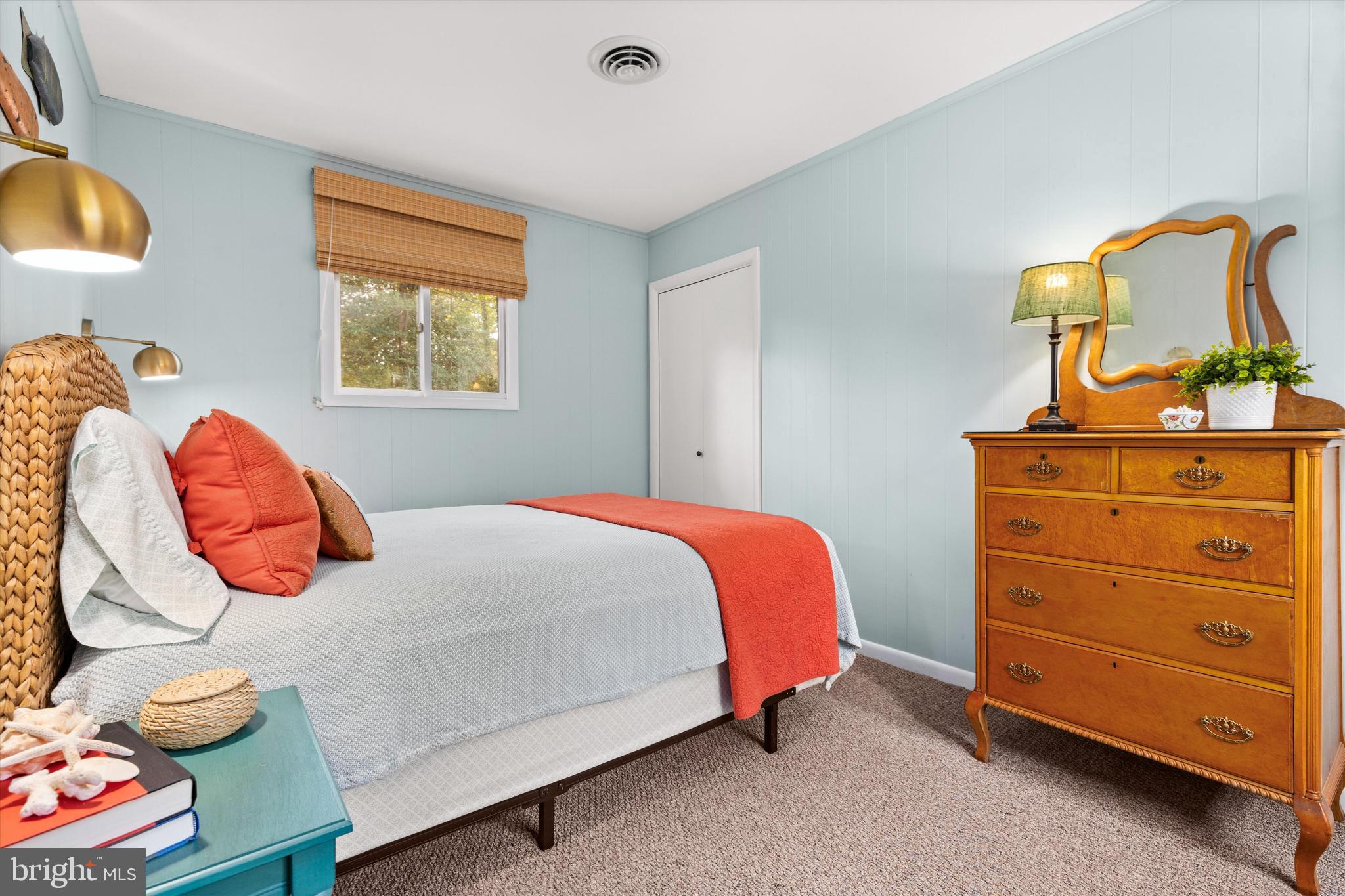 606 Spring Lake Court Bethany Beach, DE 19930 - Photo 24 of 53 a bedroom with a bed and dresser