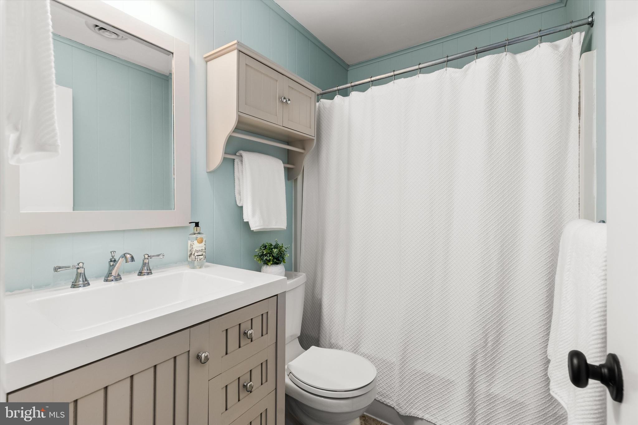 606 Spring Lake Court Bethany Beach, DE 19930 - Photo 26 of 53 a bathroom with a sink toilet and shower