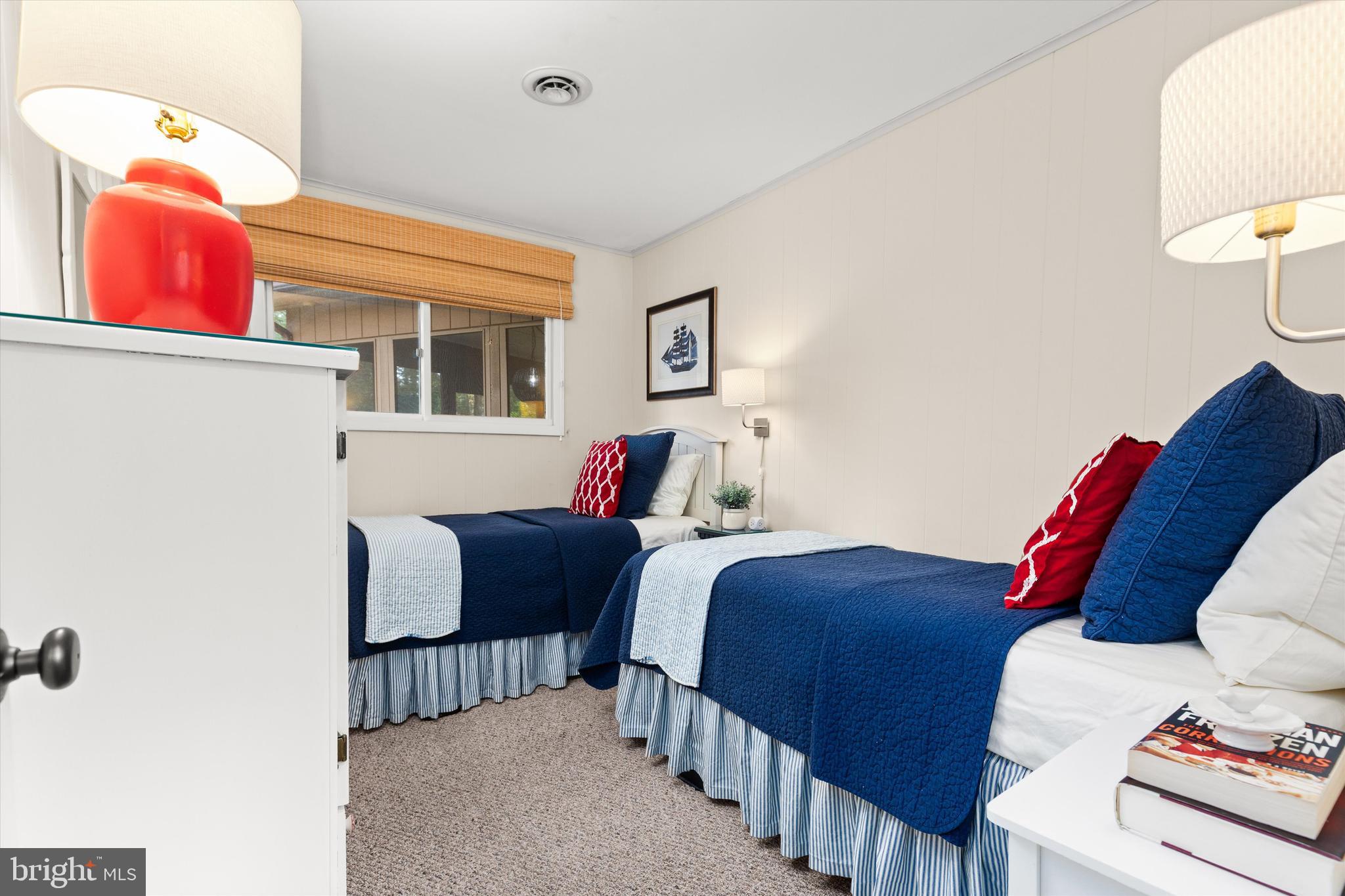 606 Spring Lake Court Bethany Beach, DE 19930 - Photo 29 of 53 a bedroom with furniture and a lamp