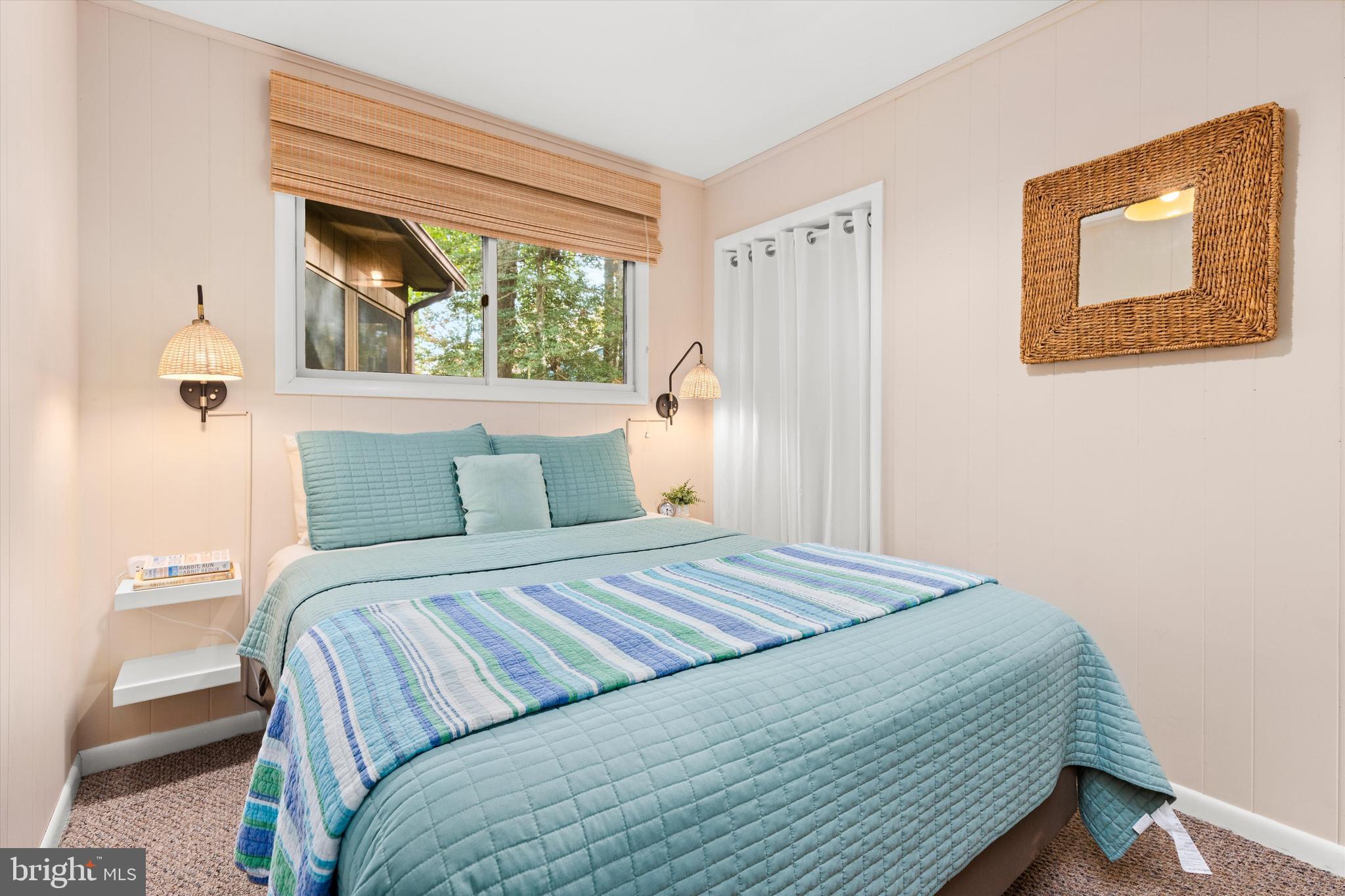 606 Spring Lake Court Bethany Beach, DE 19930 - Photo 30 of 53 a bedroom with a bed and a window