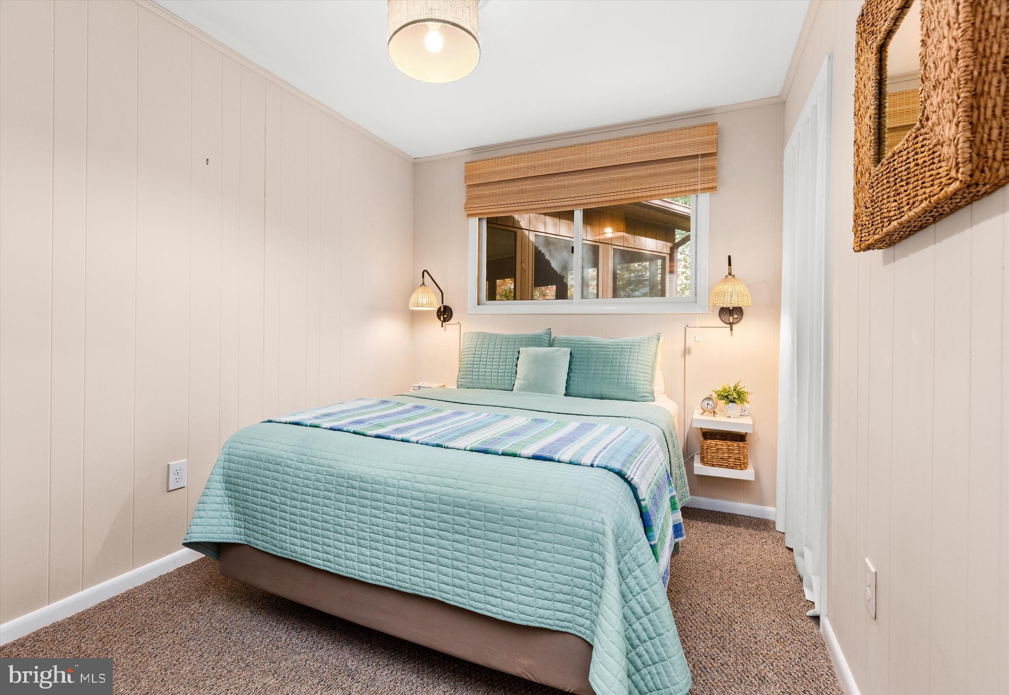 606 Spring Lake Court Bethany Beach, DE 19930 - Photo 31 of 53 a bedroom with a bed and painting on the wall