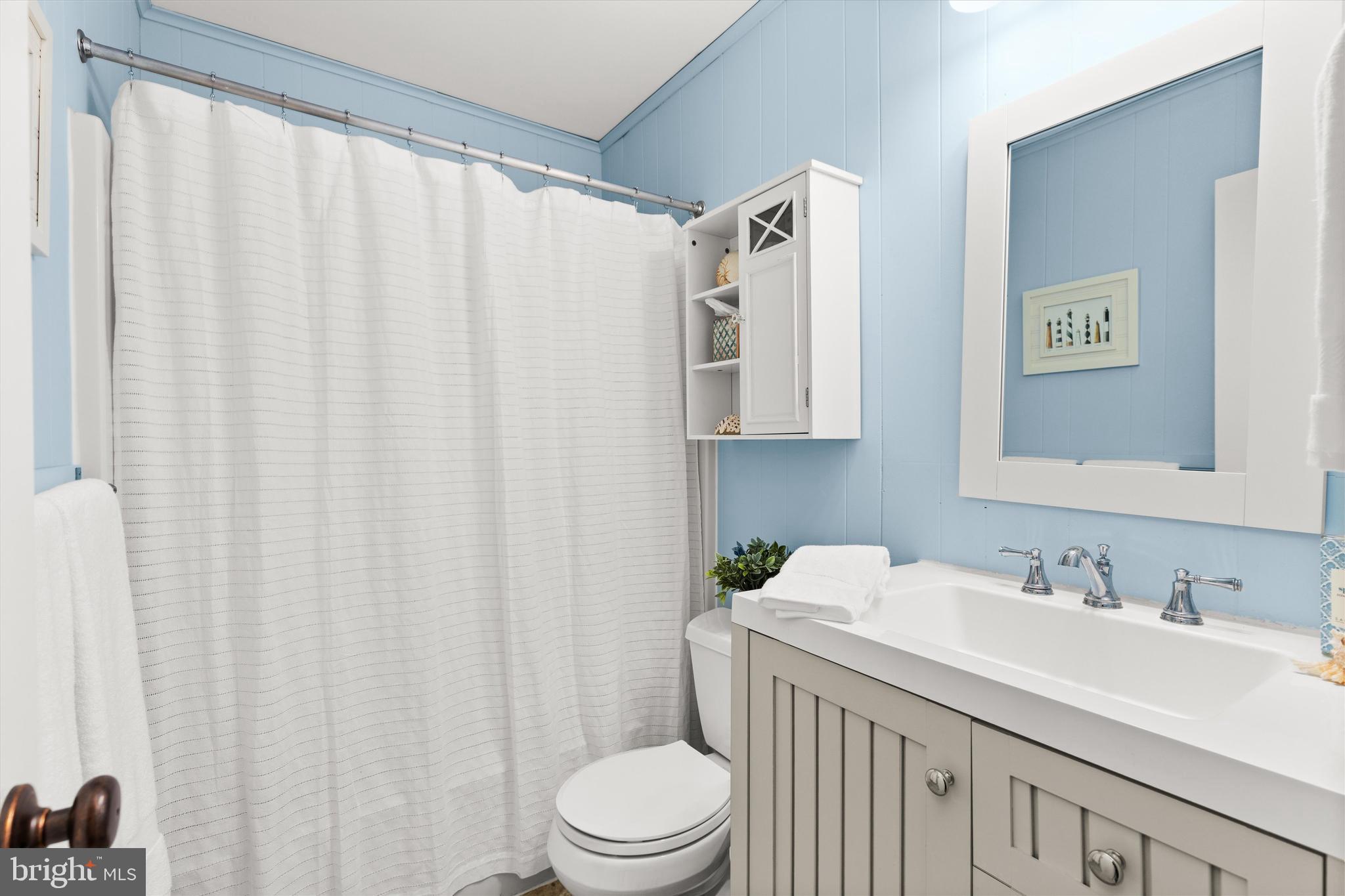 606 Spring Lake Court Bethany Beach, DE 19930 - Photo 32 of 53 a bathroom with a sink and a toilet